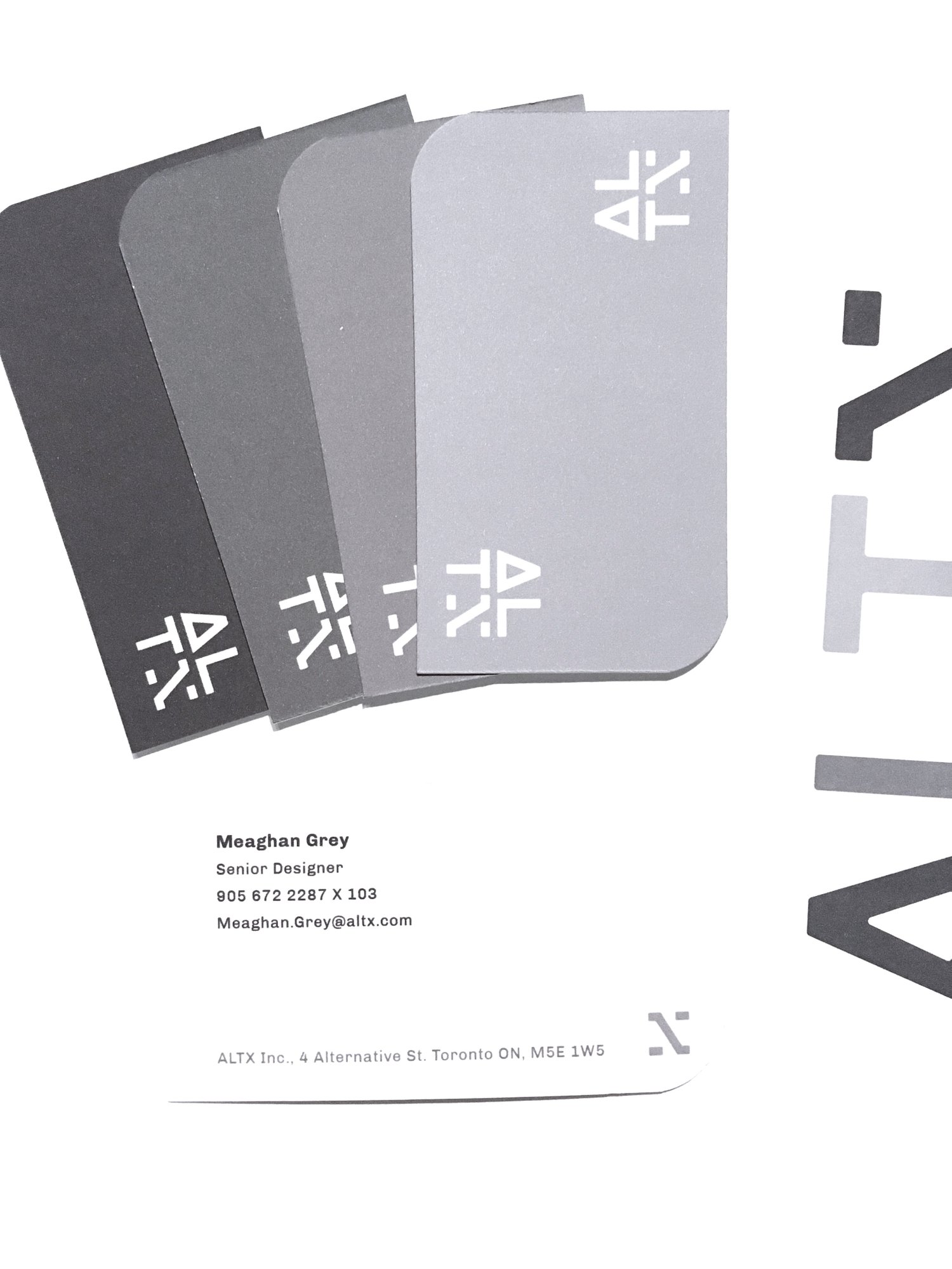 A spread of the monochromatic business cards and a letterhead stack.