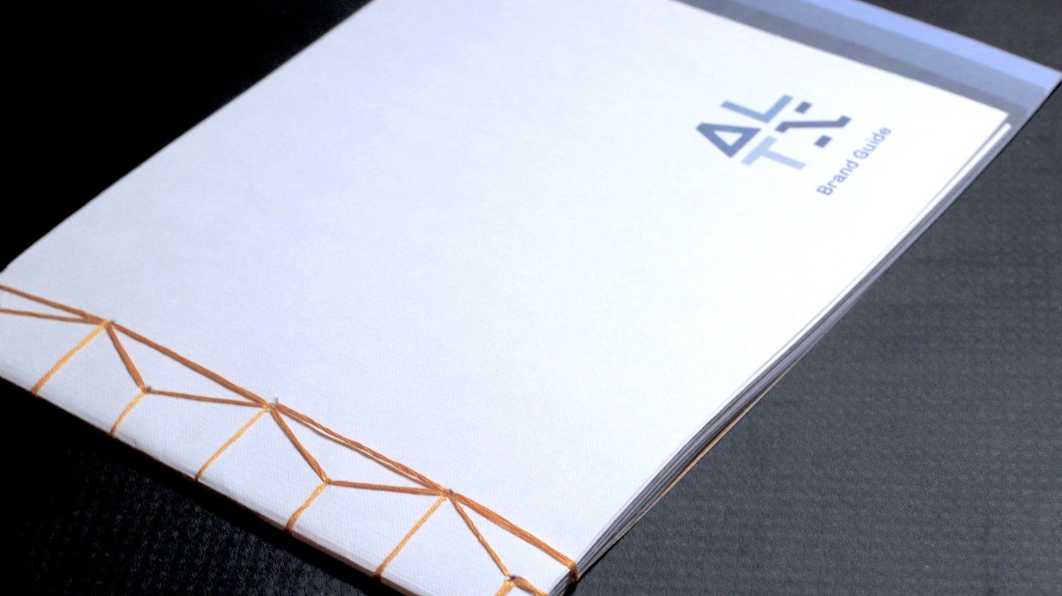 The Japanese bound ALTX brand book with a staggered edge to mark sections.